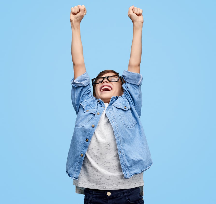 Super excited kid holding hands up